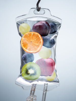 Close-up Of A Different Fruit Slices Inside Saline Bag Hanging With Hook In Hospital